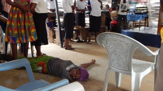 A worshiper lies on the floor after being "overwhelmed" by the Holy Spirit