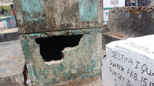 A tomb cracked at the Palm Grove Cemetery