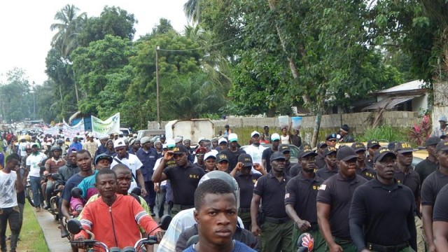 DEA officers and members of other security agencies march with students in Payneville in observance of World Drugs Day. Photo: Gbatemah Senah
