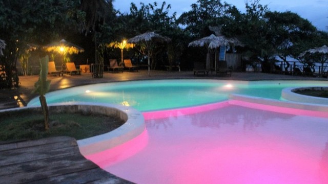 The pool at Libassa Ecolodge in Margibi glows with multiple colors at dusk. Photo: Jefferson Krua